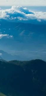 Serene mountain view wallpaper with clouds and blue sky.