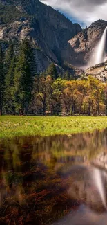 Serene waterfall and mountain landscape with tranquil lake reflection.