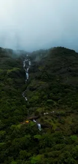 A serene mountain scene with a cascading waterfall.