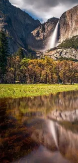 Majestic waterfall with mountain and forest view reflected in clear water.