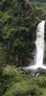 A scenic mountain waterfall with lush greenery.