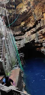 Textured cave with clear blue water.