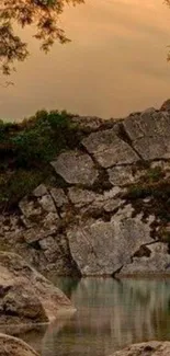 Tranquil landscape wallpaper with rocks and sunset.