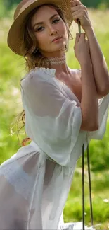 Woman in sun hat amidst lush green nature in serene setting.