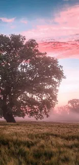 A majestic tree under a pink and blue sunset sky in a misty, serene landscape.