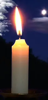 Candle glowing softly under a moonlit night sky with scattered clouds.