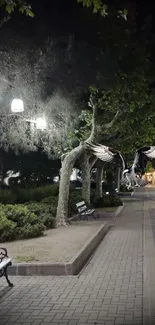 Tranquil night city pathway with illuminated benches and trees.