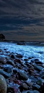 A serene night ocean scene with waves and stones under a moody sky.