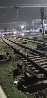 Nighttime view of railway tracks with ambient lighting.