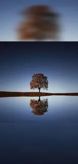 Serene night scene with tree reflecting in calm lake under a starry sky.