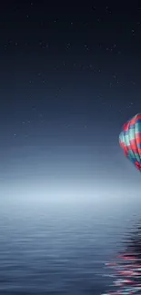 Colorful hot air balloon over night ocean.