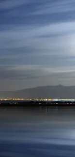 Night sky wallpaper with lake, mountain, and moon.