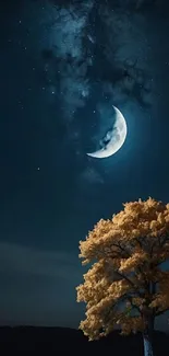 Crescent moon over tree at night.