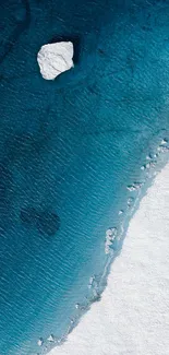 Aerial view of ocean meeting ice in serene blue tones.