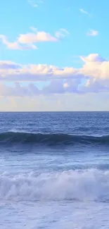 Serene ocean wallpaper with blue sky and clouds.