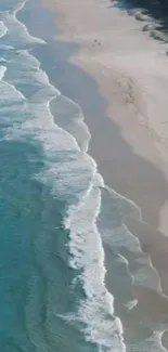 Turquoise ocean waves along a sandy beach coastline.