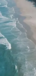 Serene beach with gentle waves and soft sand under a clear sky.