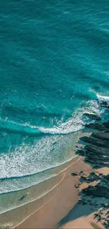 Aerial view of a beach with turquoise water and cliffs.