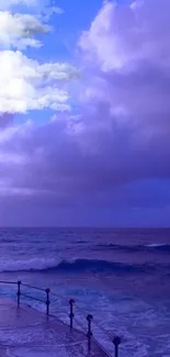 Tranquil ocean and vivid blue sky with soft clouds.