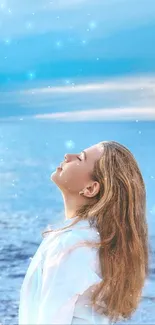 Woman enjoying ocean breeze with a vibrant blue sky.