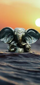 Ganesha statue in ocean at sunset.