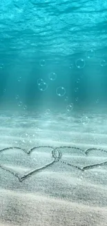 Underwater hearts in sand with ocean bubbles.