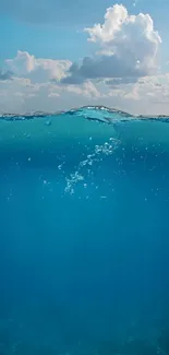 Beautiful calm ocean under a cloudy blue sky.