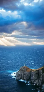 Serene wallpaper of ocean with lighthouse, clouds, and sunlight rays.