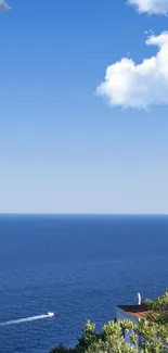 Lighthouse overlooking serene blue ocean and sky.