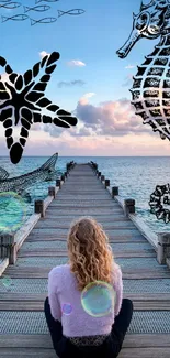 A woman sits on a pier overlooking the ocean with artistic sea creatures.