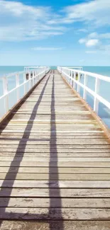 Serene pier view with blue sky and ocean background.