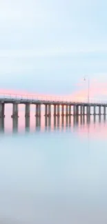 Tranquil pier over calm ocean with pastel skies.