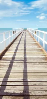 Serene pier and blue ocean under a clear sky.