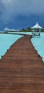 Calm ocean pier at night with starry sky and turquoise waters.