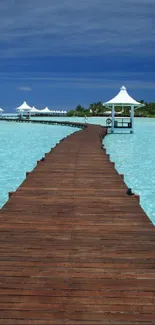 Serene blue ocean pier stretching into the horizon with azure skies and water.