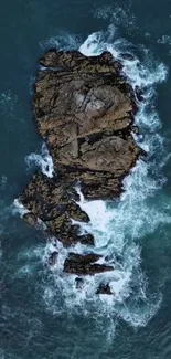 Aerial view of rocky island surrounded by ocean waves.