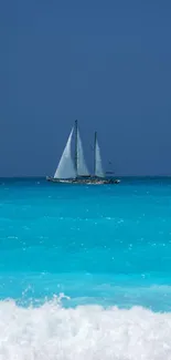 Sailboat on clear azure ocean beneath a vibrant blue sky.