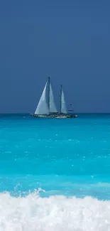 A serene ocean with sailboat against blue skies and turquoise waters.