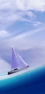 A sailboat gracefully glides through blue ocean waters under a clear sky.