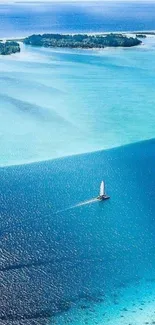 Sailboat on a turquoise ocean near islands.