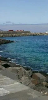 Serene ocean view with rocky shoreline and vibrant blue waters.