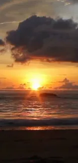 Serene ocean sunset with golden sky and calm waves at the beach.