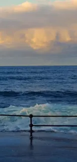 A peaceful ocean view during sunset with blue waters and a warm sky.