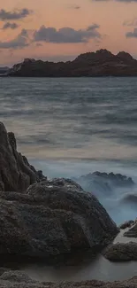 Serene ocean sunset with waves and cliffs.