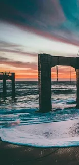 Tranquil ocean sunset with pier ruins and colorful sky.