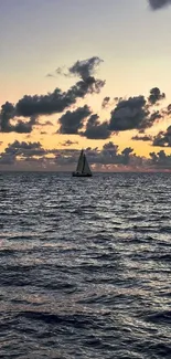 Solitary sailboat at sunset on a calm ocean.