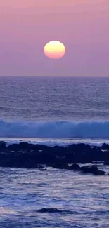 A serene sunset over a tranquil ocean with a lavender sky.