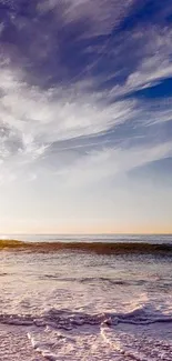 Serene ocean sunset with gentle waves and soft purple clouds.