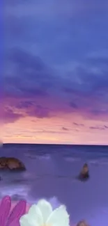 Serene ocean sunset with purple sky and flowers.