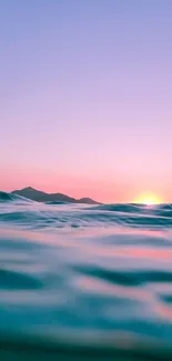 Serene ocean waves under a pink sunset sky.